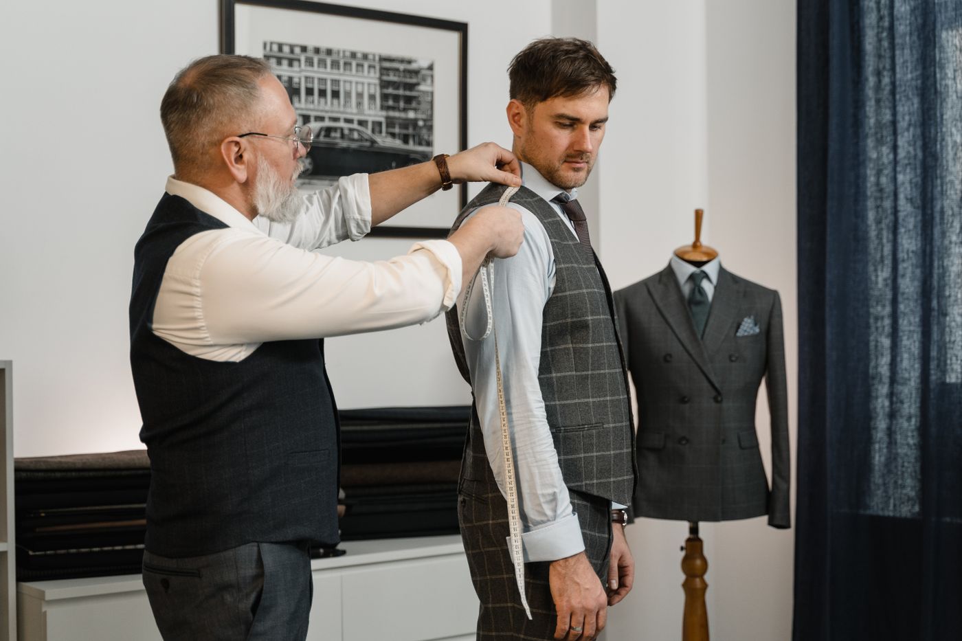 Master tailor measuring a client for a custom fit